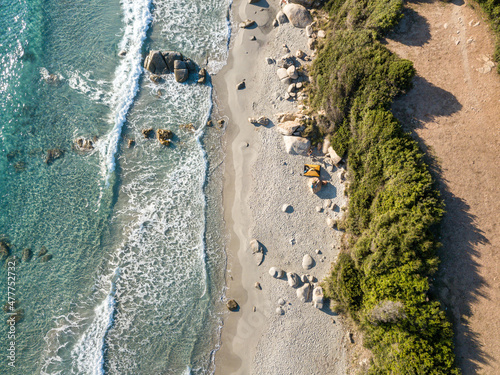 Beach from above with a yellow tent on Sardinia