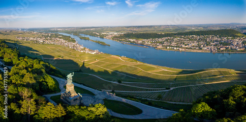 Luftaufnahme mit Drohne vom Niederwalddenkmal und Weinbergen bei Rüdesheim am Rhein während des Sonnenuntergangs and einem teilweise bewölkten Tag im Sommer, Rheingau Hessen photo
