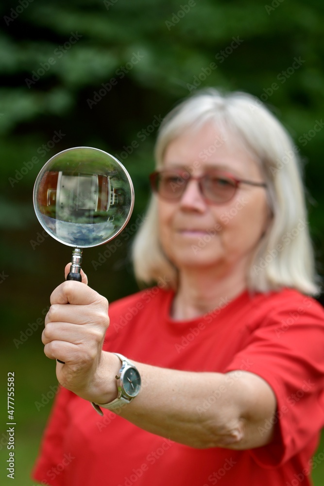 Portrait of a woman holding a magnifying glass