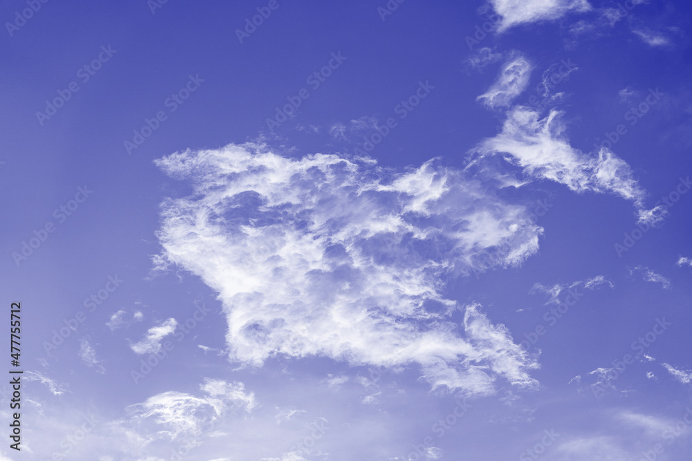 Blue sky background with white clouds during sunset. Trendy color of the year 2022 . Ultra Violet creative and moody color of the picture Blue sky background with white clouds during sunset. Trendy color of the year 2022 . Ultra Violet creative and moody color of the picture