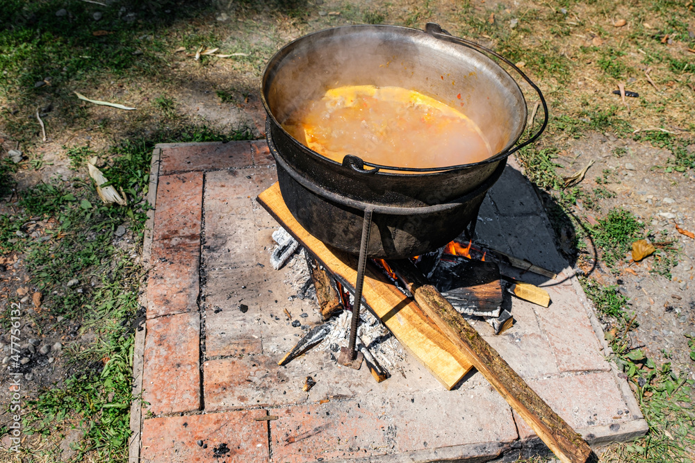 Romanian traditional food prepared at the cauldron on the open fire Romanian traditional food prepared at the cauldron on the open fire