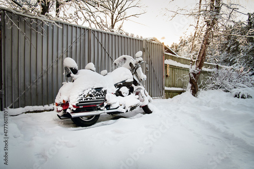 Motorcycle under the snow on winter parking