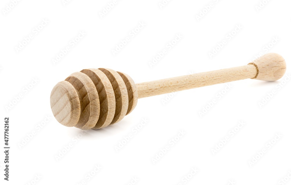 A wooden drizzler dipping stick for serving honey isolated on a white background A wooden drizzler dipping stick for serving honey isolated on a white background