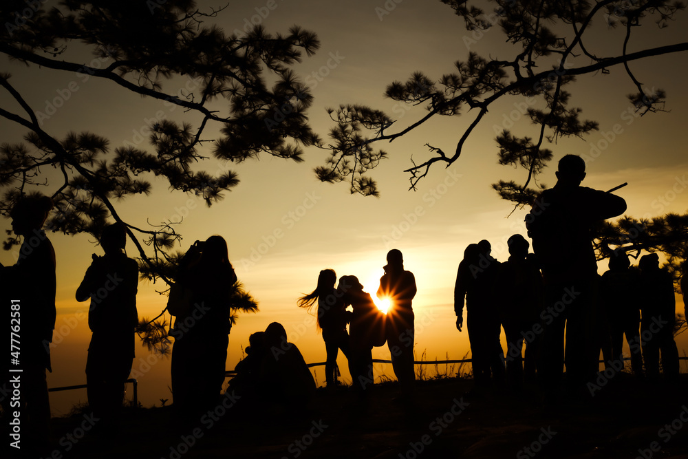 Silhouette of tourists watching the sun at dawn  , Phu Kradueng National Park ,Thailand