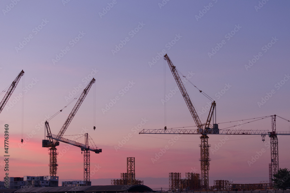 White containers, yellow steel tower cranes, near green fields, White containers, yellow steel tower cranes, near green fields,