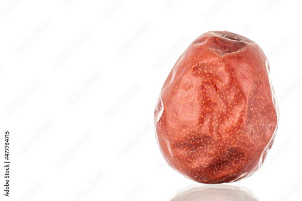 One dried unabi berry, close-up, isolated on white. One dried unabi berry, close-up, isolated on white.