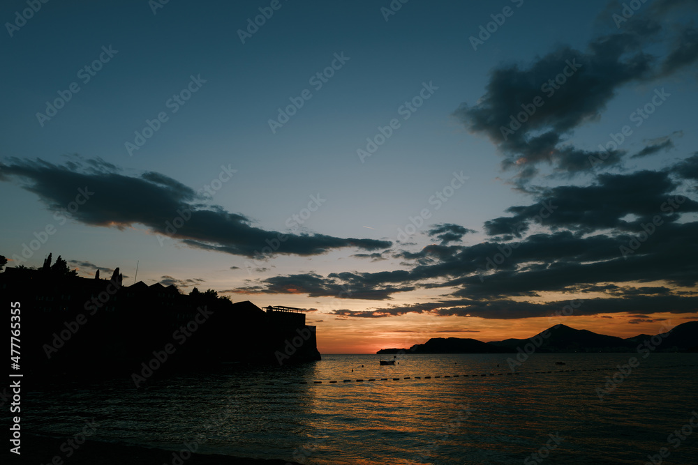 Sveti Stefan Island against the background of an orange sunset