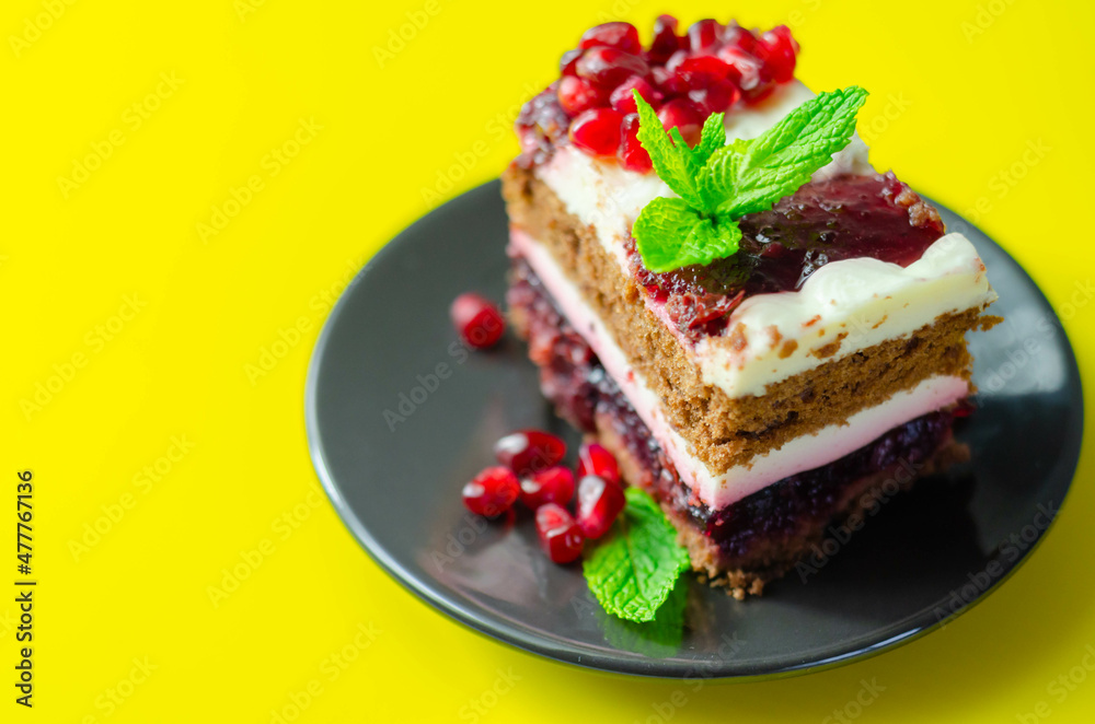 Colorful multi-layered cream chocolate cake with cherry jam and pomegranate Colorful multi-layered cream chocolate cake with cherry jam and pomegranate
