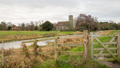 Photo A wooden fence and gate securing entry and exit to the public footpath along the River Bure in the Norfolk village of Buxton