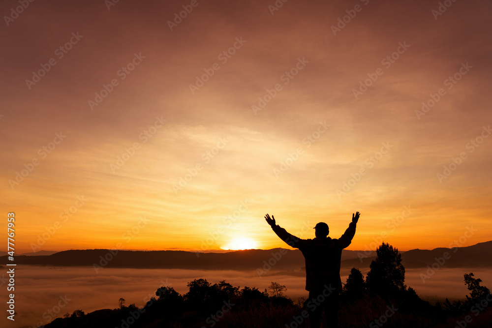 silhouette of people standing on the hill with sunrise or sunset time.