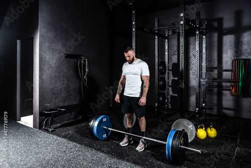 Fotografie Young strong active athlete muscular fit man with big muscles preparing and conc