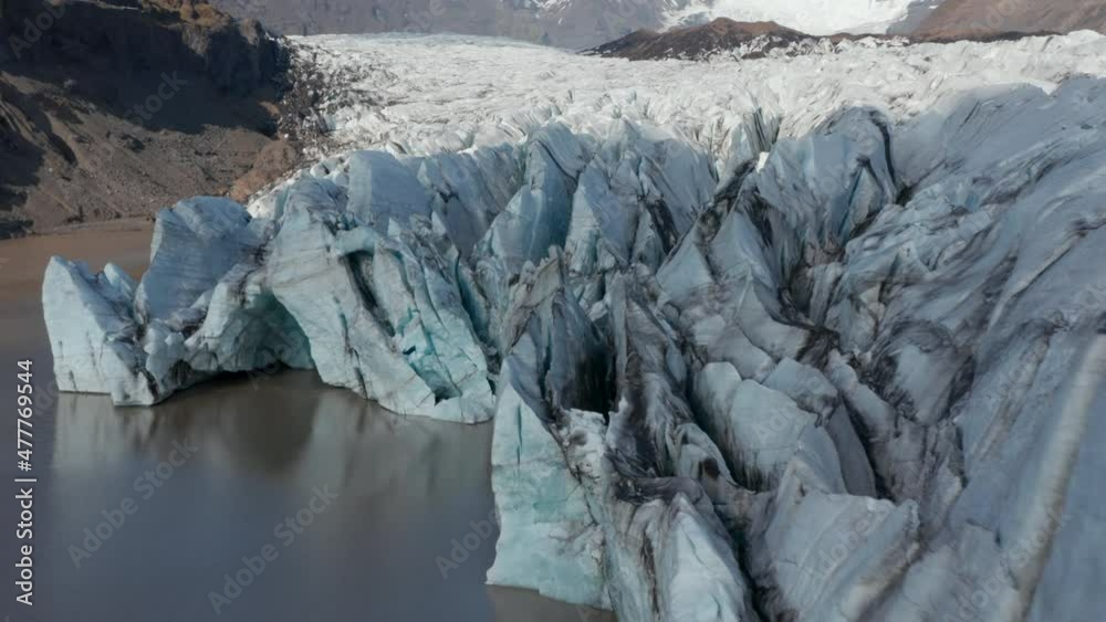 Aerial view floating icebergs of Breidamerkurjokull glacier tongue in Iceland. Drone view snow capped mountains and ice formations in Vatnajokull national park. Breidamerkurjokull glacier Aerial view floating icebergs of Breidamerkurjokull glacier tongue in Iceland. Drone view snow capped mountains and ice formations in Vatnajokull national park. Breidamerkurjokull glacier