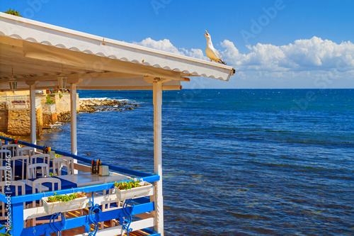 Seaside landscape - view of the cafe on the embankment by the sea, in the Old Town of Nessebar, on the Black Sea coast of Bulgaria