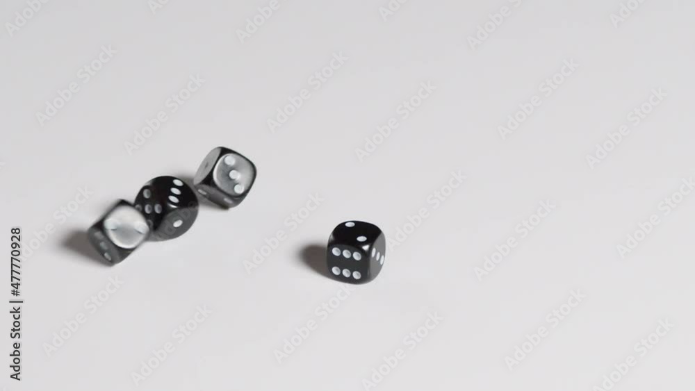 Six black dices rolling in slow motion on a white blackground. Six black dices rolling in slow motion on a white blackground.