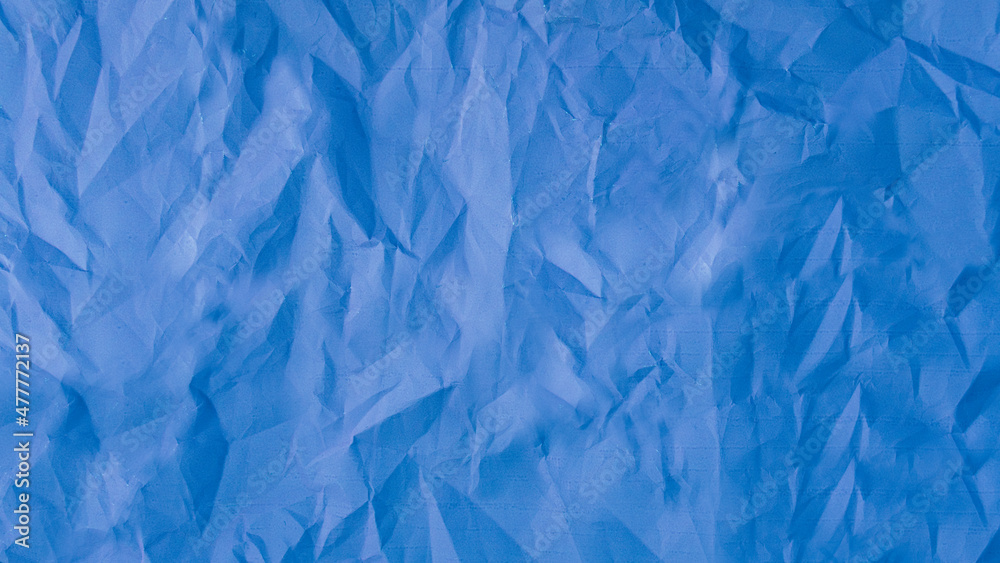 Texture of blue crumpled paper. Selective focus.
 Surface of crumpled blue paper. paper textures and backgrounds. Selective focus

