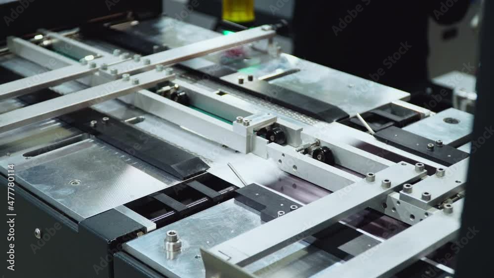 conveyor printing of photos in production. an automated machine prints photographs. factory for the production of books. conveyor printing of photos in production. an automated machine prints photographs. factory for the production of books.