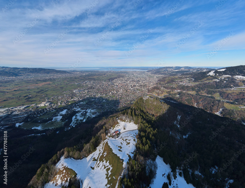 Aerial view over the town Dornbirn and the mountain Karren. In the background is lake Constance. Austria.
