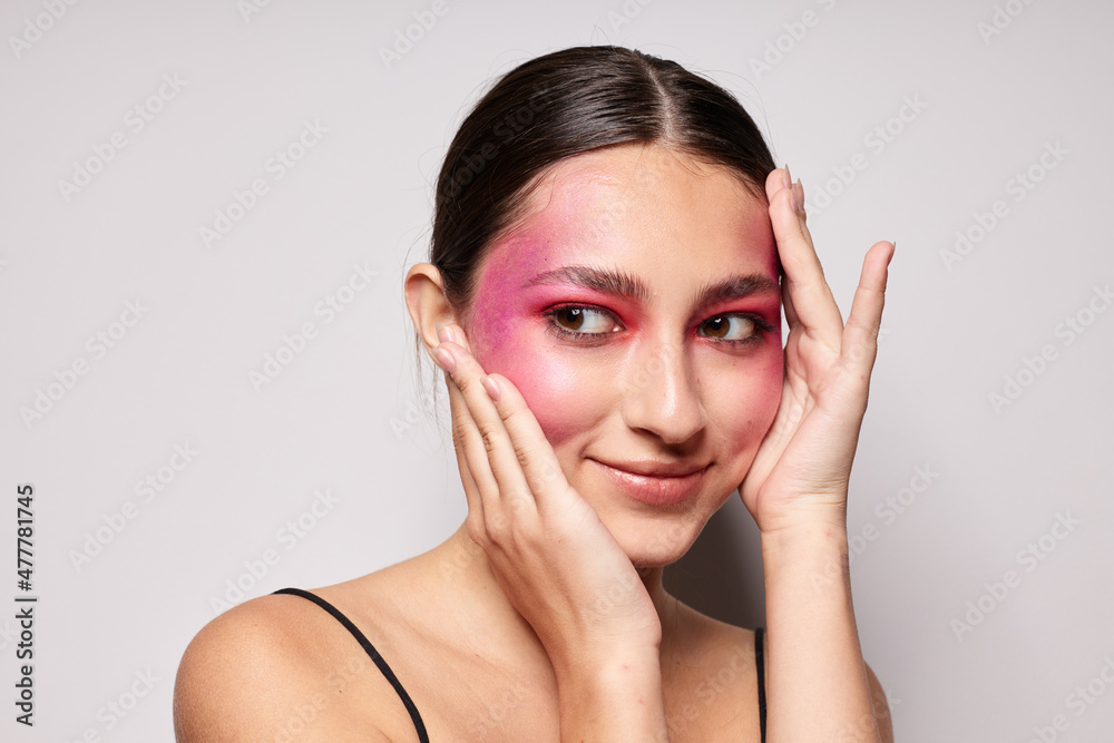 fashionable woman pink face makeup posing attractive look light background unaltered fashionable woman pink face makeup posing attractive look light background unaltered