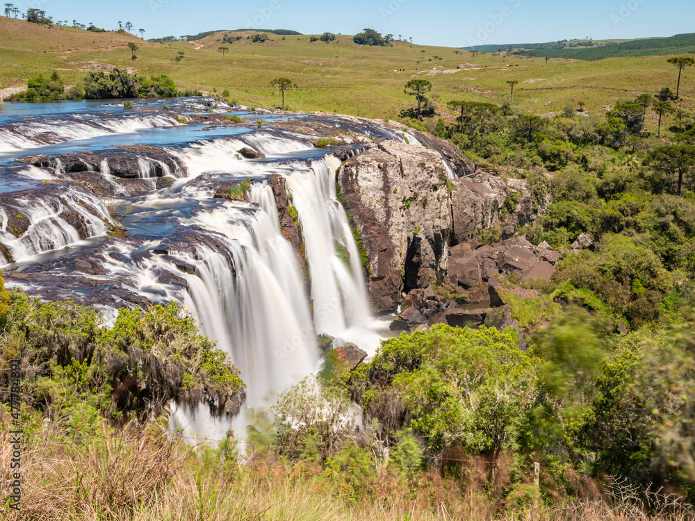 Obraz premium Waterfall with fields and forest around