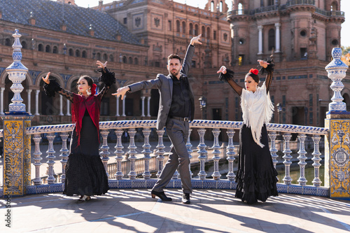 People dancing flamenco in the middle of a traditional bridge