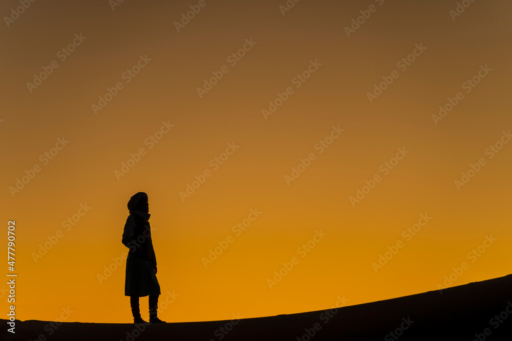 A Lone Nomad Is Silhouetted Against The Sky As The Sun Rises On The Sahara Desert In Morocco, Arica