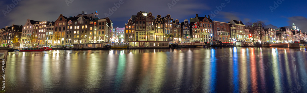 Panorama of the Amsterdam waterfront in night illumination.