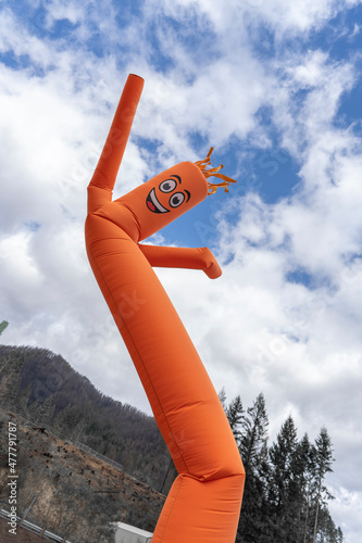 orange inflatable arm flailing tube man