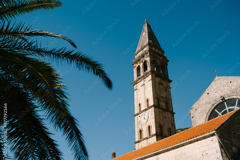 Bell tower of the church of St. Nicholas on the background of sky. Montenegro