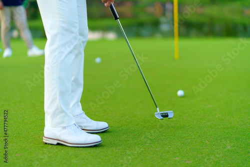 Golfer preparing for a putt Golf ball on the green during golfcourse