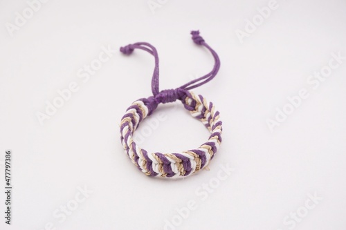 An isolated ethnic bracelet on white background. The bracelet is made off the various rope