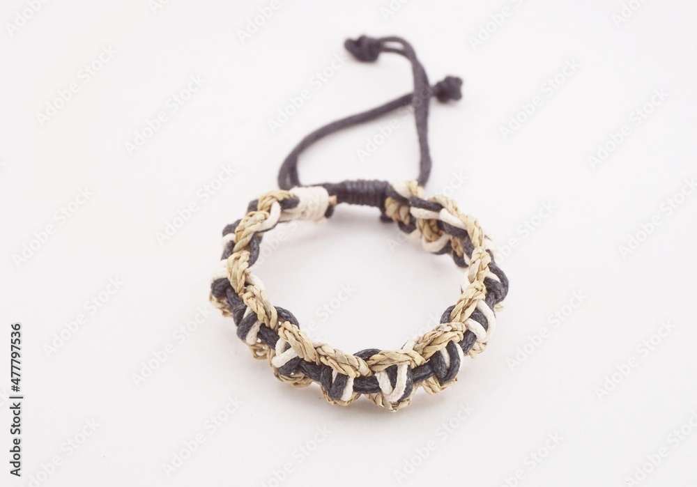 An isolated ethnic bracelet on white background. The bracelet is made off the various rope