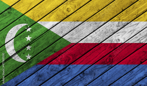 Comoros flag on wooden background. 3D image