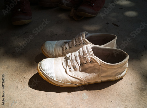 White student shoes were placed on the cement floor.