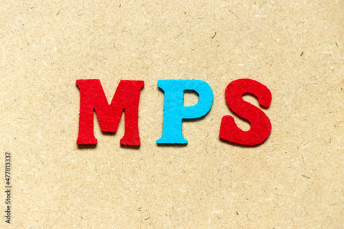 Color cloth alphabet letter in word MPS (Abbreviation of Master Production Schedule or Mucopolysaccharidosis) on wood background