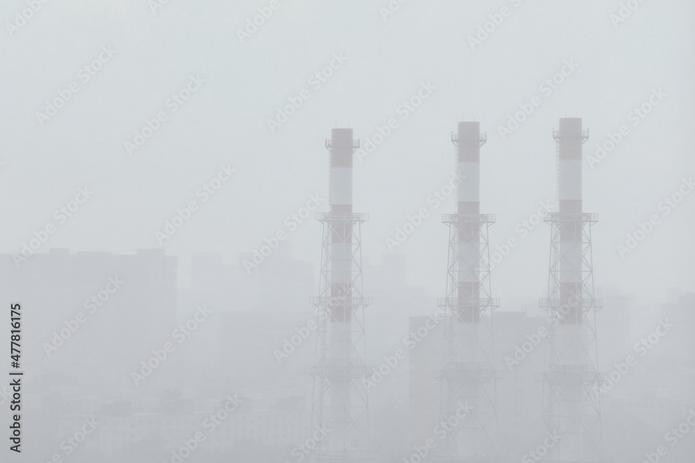 Obraz premium A city in the rain. The pipes of the factory.