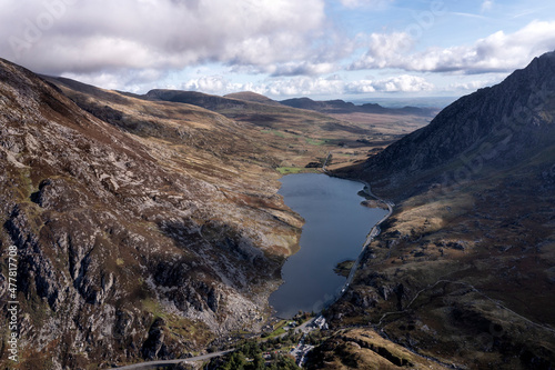 Aerial view of flying drone Epic Autumn Fall landscape image of view along Ogwen vslley in Snowdonia National Park with moody sky and mountains © veneratio