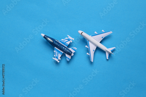 Military fighter and passenger plane on a blue background. Toy Models