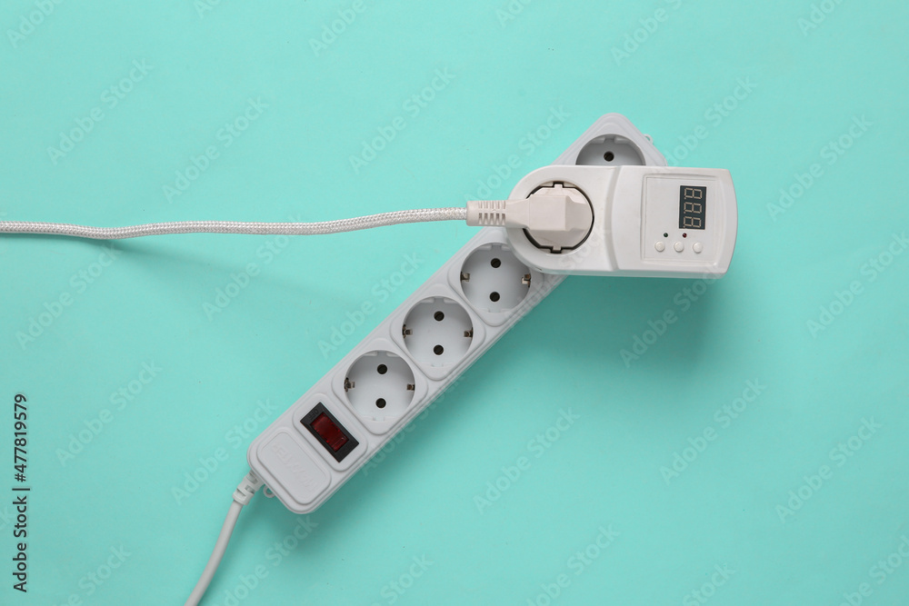 Electrical Extension cord and socket with fuse and electrical plug on blue background Electrical Extension cord and socket with fuse and electrical plug on blue background