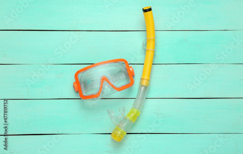 Diving mask with snorkel on blue background. Travel concept. Top view. Flat lay