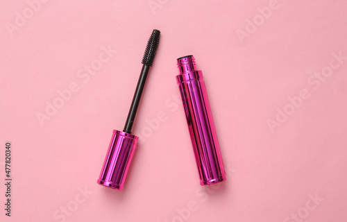 Eyelash brush with mascara on pink background, beauty concept