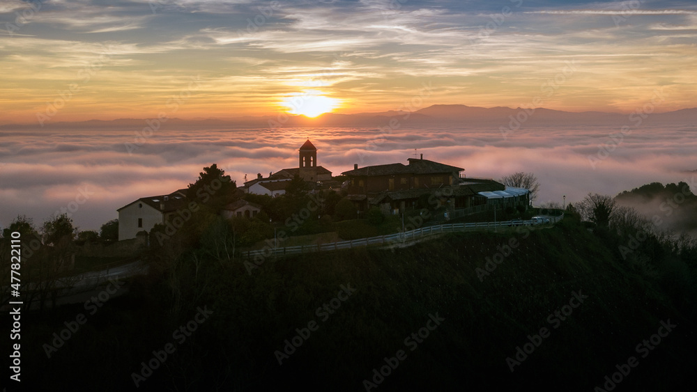 aerial view of the village of casteldimezzo and mount san bartolo with fog