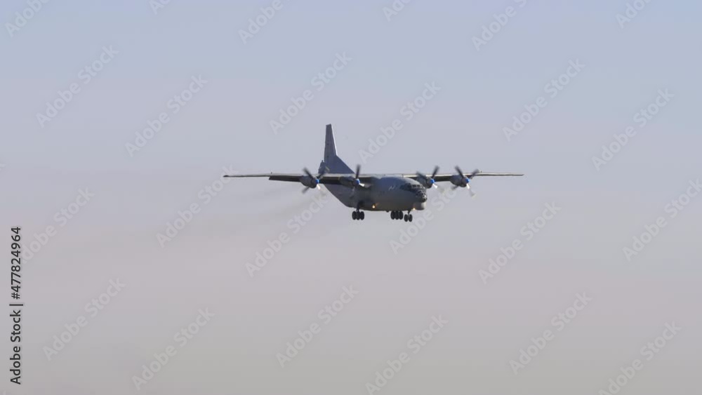 Military transport aircraft. Transport turboprop aircraft approaching before landing at Novosibirsk airport. Soviet aircraft flies, long shot Military transport aircraft. Transport turboprop aircraft approaching before landing at Novosibirsk airport. Soviet aircraft flies, long shot