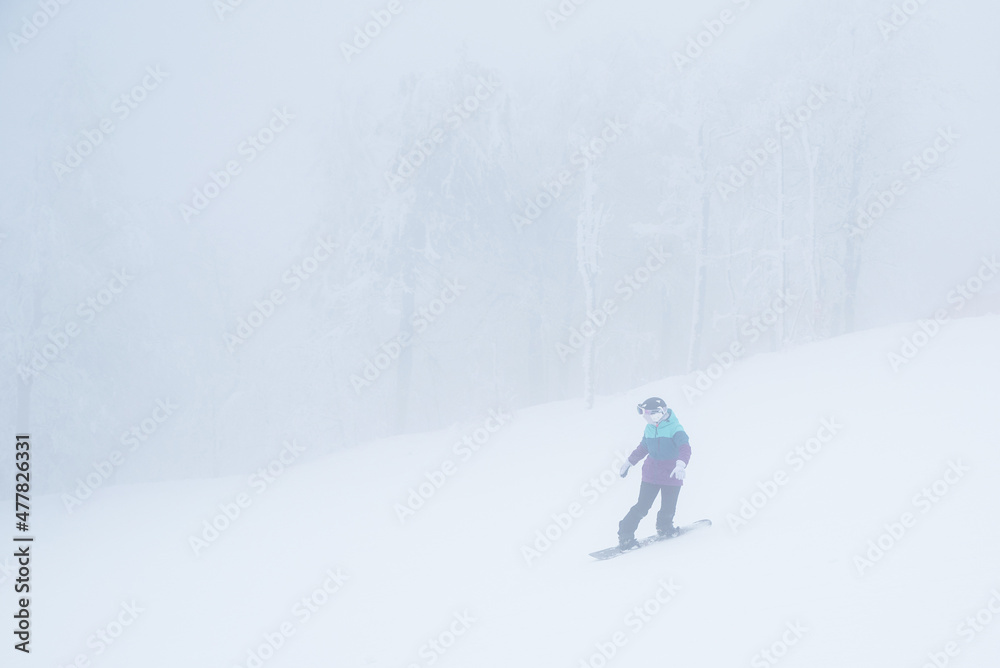 Snowboarder in white winter nature