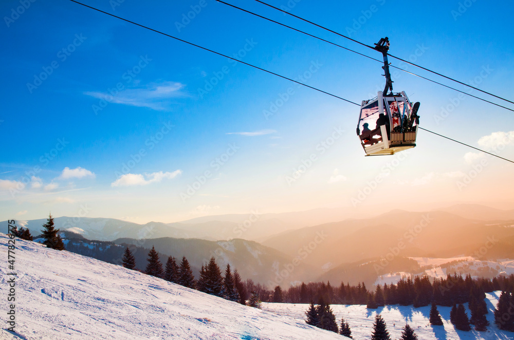 Ski lift cabine in ski resort. Sunrise light in background. Orange edit space for your montage. Ski lift cabine in ski resort. Sunrise light in background. Orange edit space for your montage.