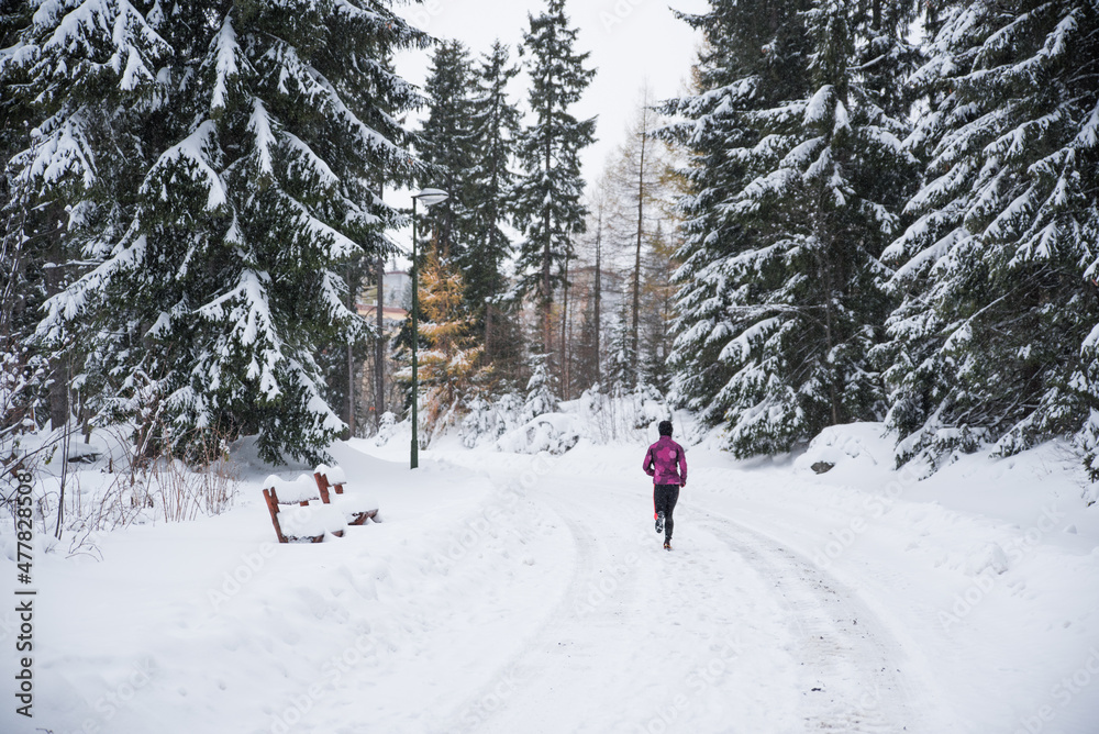 Trail runner in white winter nature. Active life in winter, sport photo, white edit space