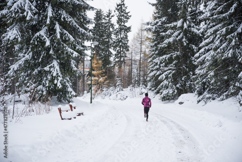 Trail runner in white winter nature. Active life in winter, sport photo, white edit space