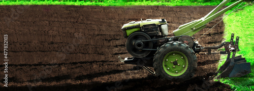 motor cultivator in a plowed field, preparing the ground for planting potatoes. High quality photo photo