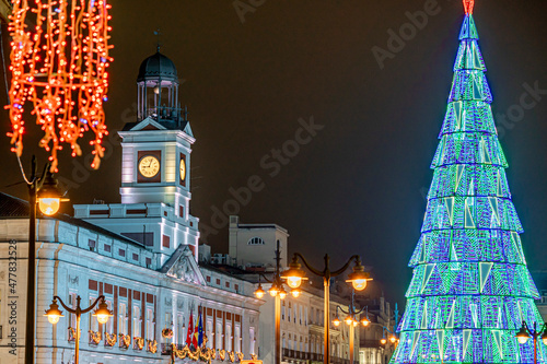 Christmas in Puerta del Sol, in the city of Madrid with lighting and typical decoration, the clock and christmas tree