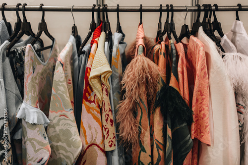 Fashion outfits hanging in a row at the backstage  photo