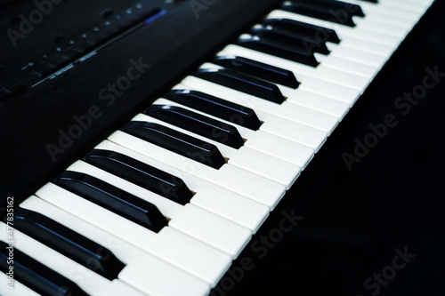 Electronic synthesizer keys. Fragment of a musical instrument on a dark background. Close-up